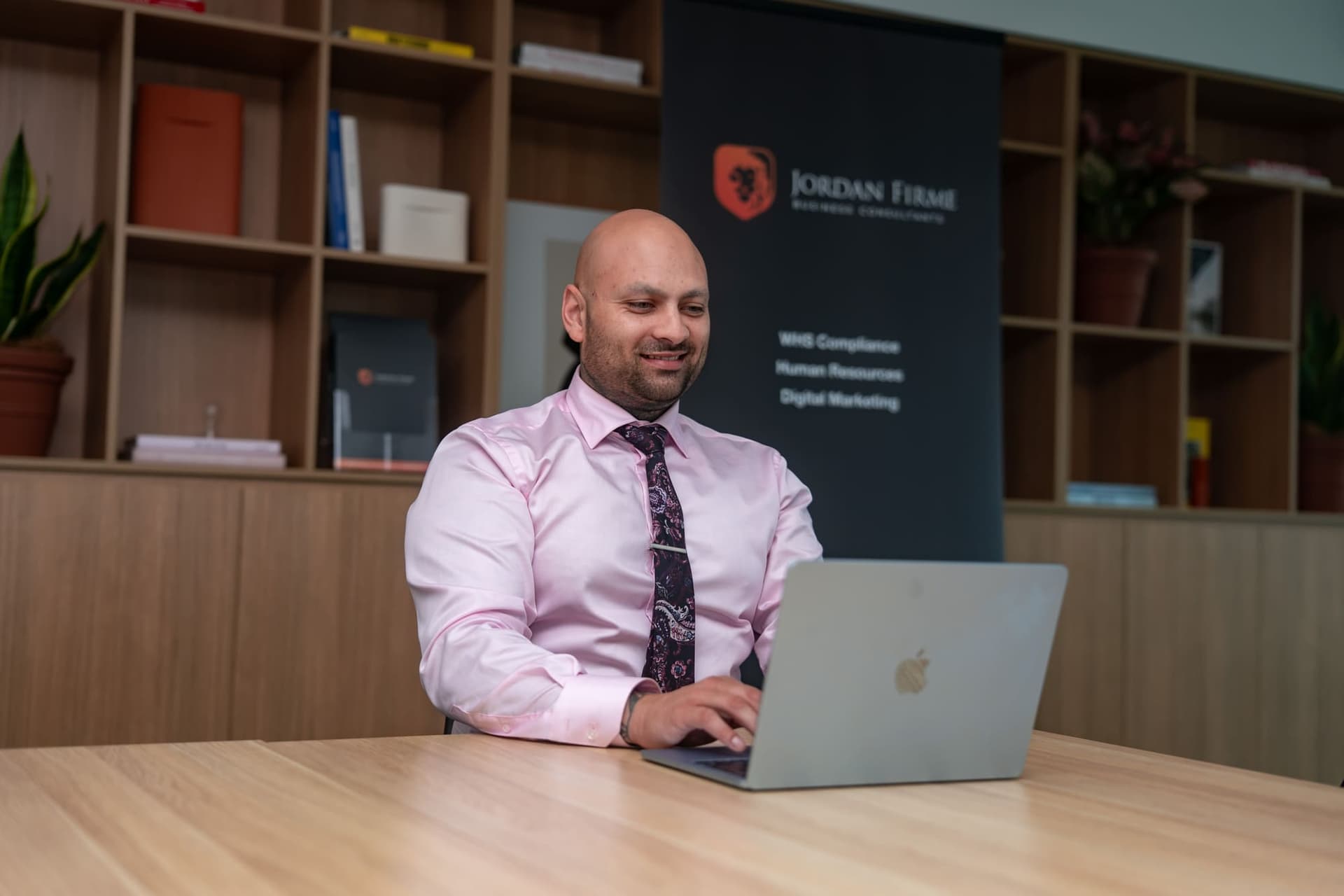 Shiva Singh, Founder and CEO of Jordan Firme Business Consultants, reviewing client compliance systems